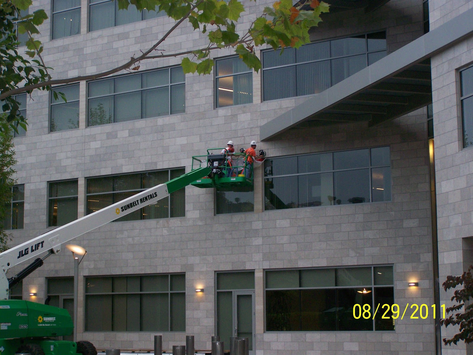 Two men working on a tile and stone project for a building after the tile and stone consultant finalizes the deal.