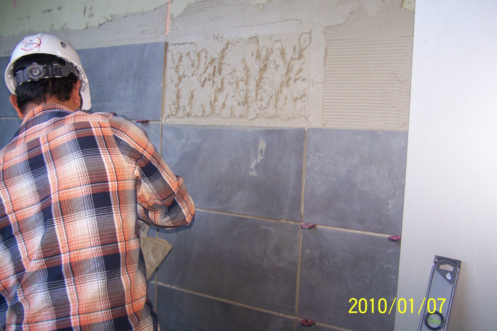 Man working on tile installation project as a contractor.