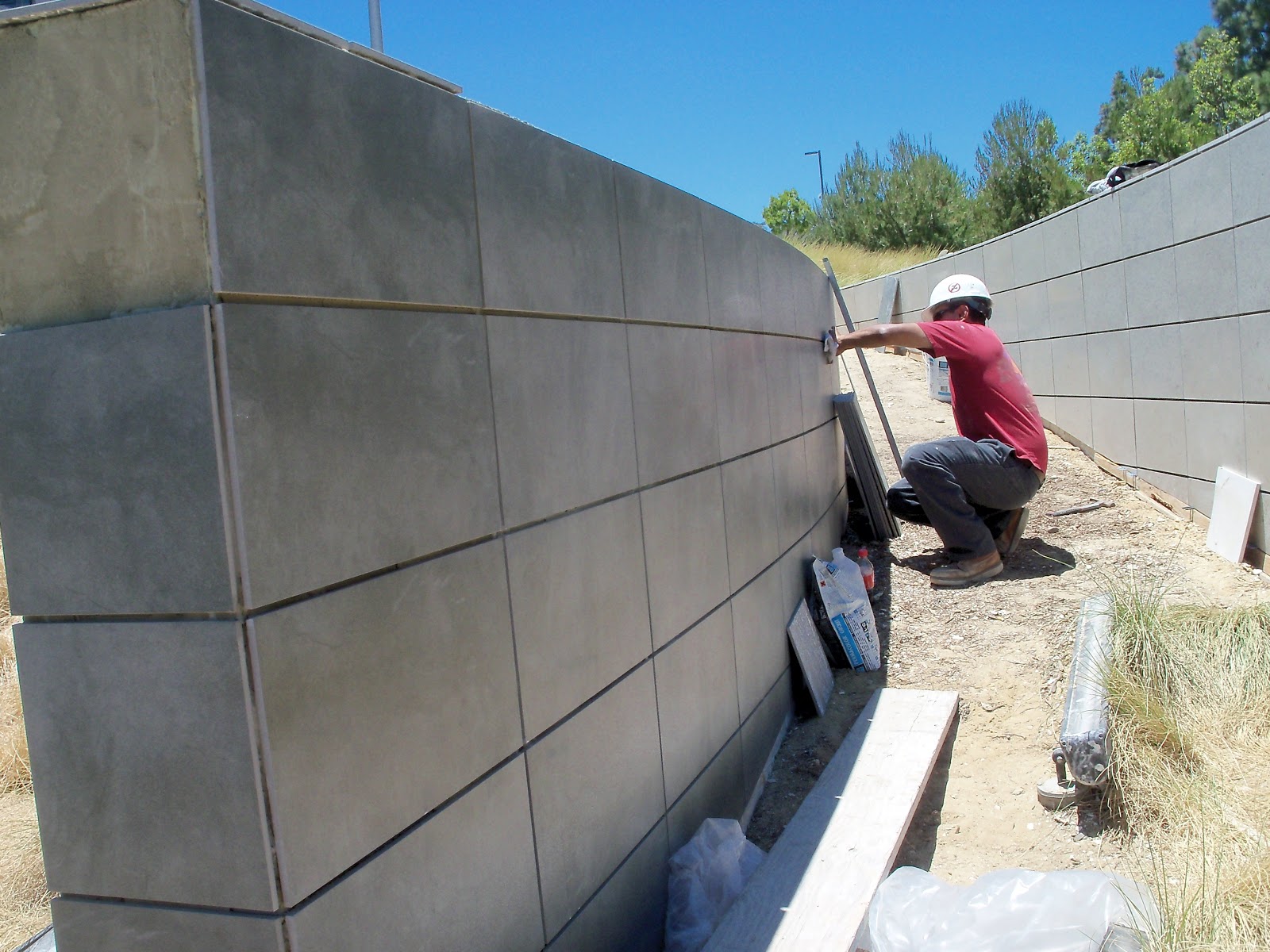 Man inspecting and installing tile and stone project as part of a contractual  service.